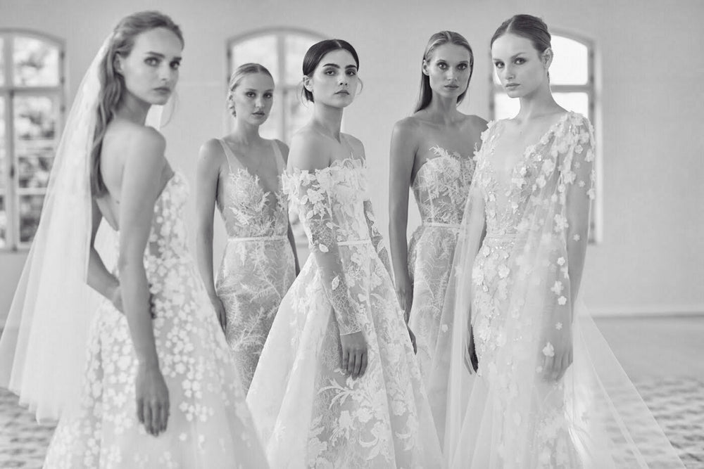 Five embroidered, beaded, and lace bridal gowns from Mira Zwillinger's Spring Summer 2023 wedding dress collection, available at Carine's Bridal Atelier in Washington, D.C.